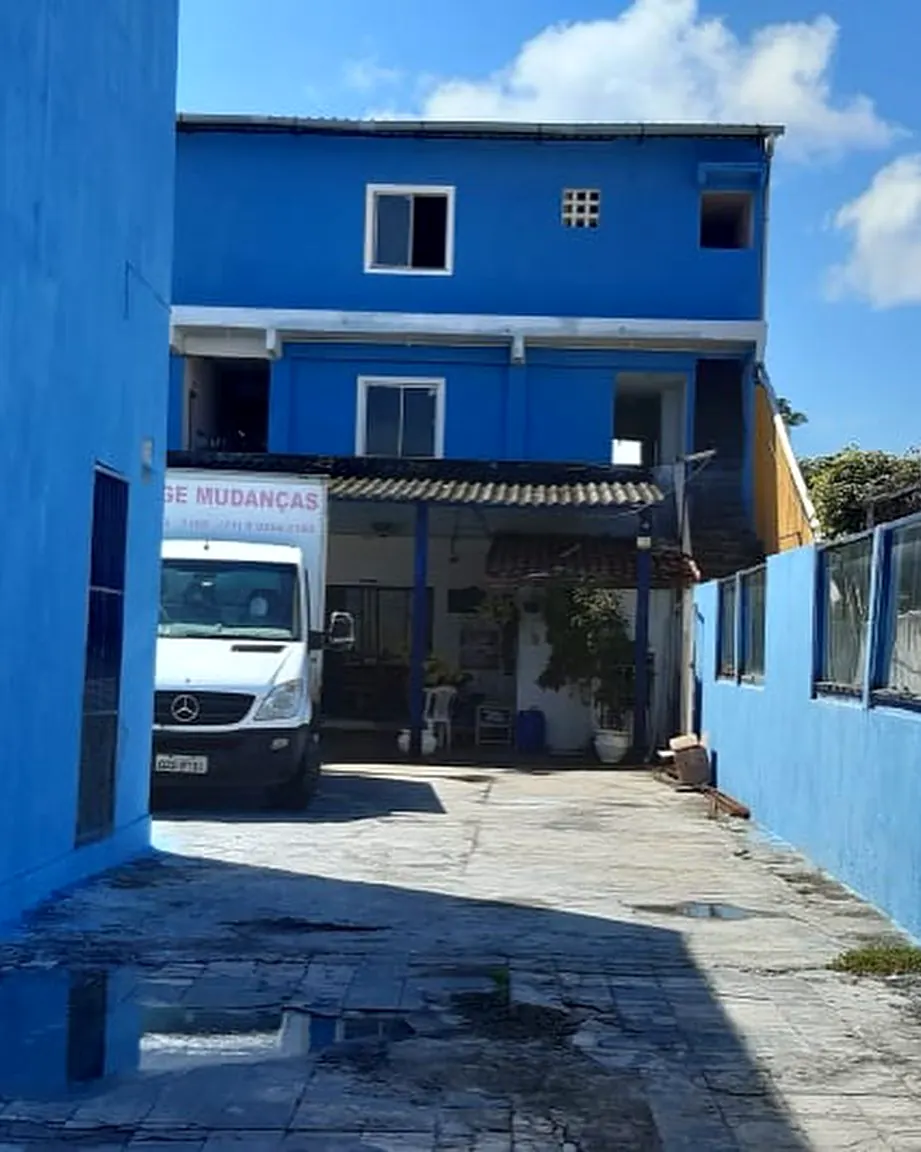 Sede azul da empresa em Stella Maris, com um caminhão na entrada
